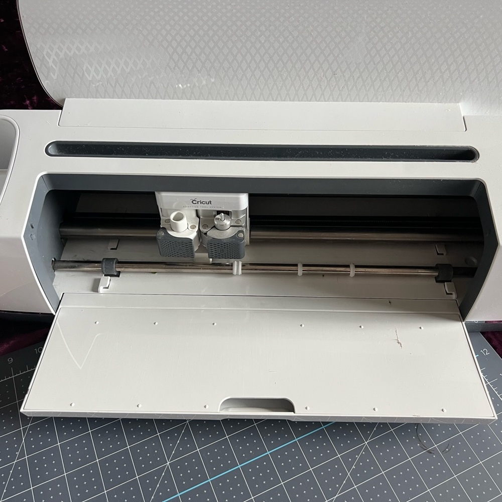 Cricut Maker machine, pink mat and cricut tools